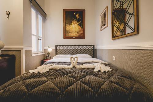 a bedroom with a large bed with a blanket at pension Acronafplia ( building C ) in Nafplio