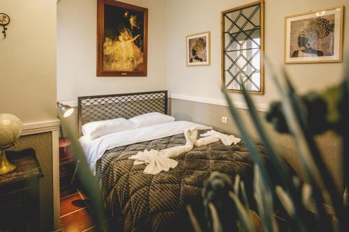 a bedroom with a bed with flowers on it at pension Acronafplia ( building C ) in Nafplio