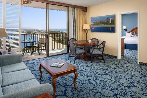 a living room with a couch and a table at Catamaran Resort Hotel and Spa in San Diego