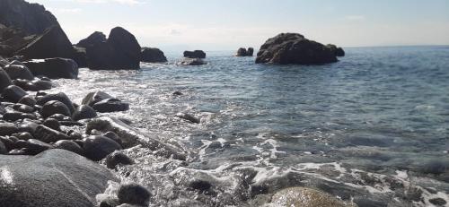a group of rocks in the water near the ocean at Case Vacanze Macchione in Capo Vaticano