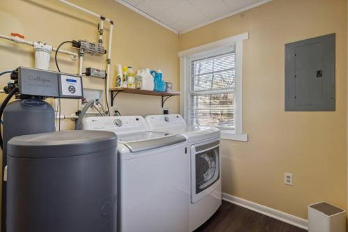 a laundry room with a washing machine and a window at Valley Vista-Mins to SkylineDrive-Hot Tub-King, Queen Beds in Front Royal
