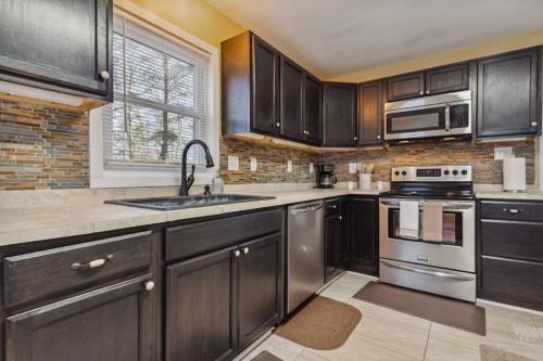 a kitchen with stainless steel appliances and a window at Valley Vista-Mins to SkylineDrive-Hot Tub-King, Queen Beds in Front Royal