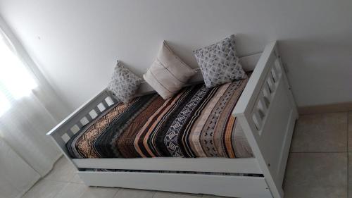a white bed with a blanket and pillows on it at Nehuen APartB in Neuquén