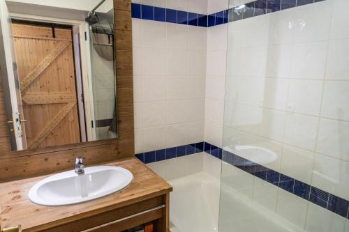 uma casa de banho com um lavatório e um chuveiro em Résidence Le Parc Des Airelles - 2 Pièces pour 7 Personnes 621 em Les Orres