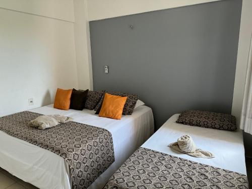 two beds sitting next to each other in a room at Apto. Beverlly Hills, Próx. Beach Park in Aquiraz