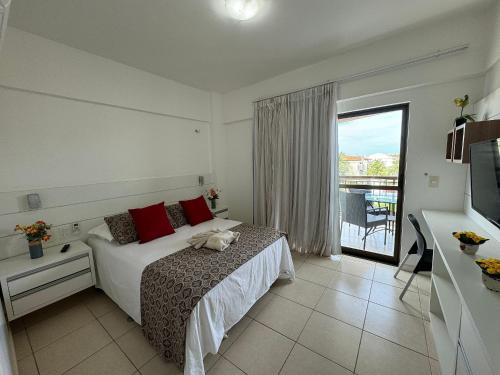 a bedroom with a bed and a large window at Apartamento Beverly Hills - Próximo ao Beach Park in Aquiraz