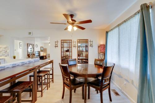 a dining room with a table and chairs and a ceiling fan at Near Airport and Dtwn Breezy Fresno Home! in Fresno
