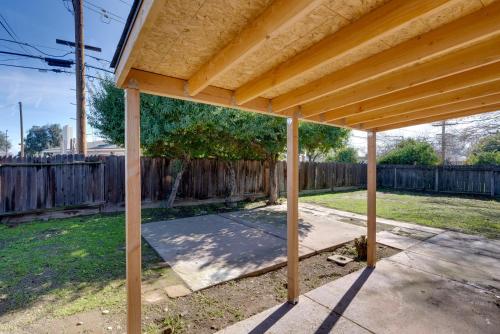 a wooden pergola in a backyard with a fence at Near Airport and Dtwn Breezy Fresno Home! in Fresno