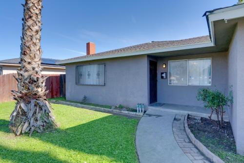 a palm tree in front of a house at Near Airport and Dtwn Breezy Fresno Home! in Fresno