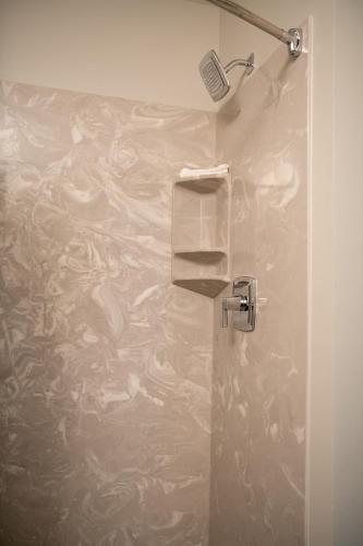 a bathroom with a shower with a plastic wall at French Quarter Suites Hotel in New Orleans