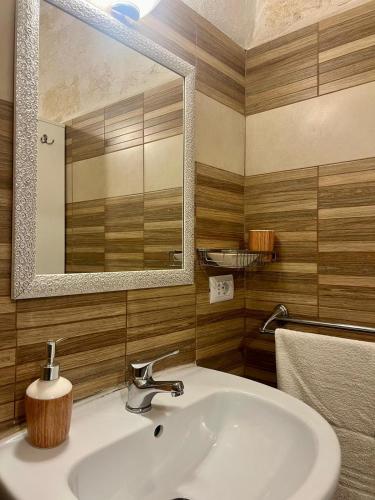 a bathroom with a sink and a mirror at Casa Monopoli in Monopoli