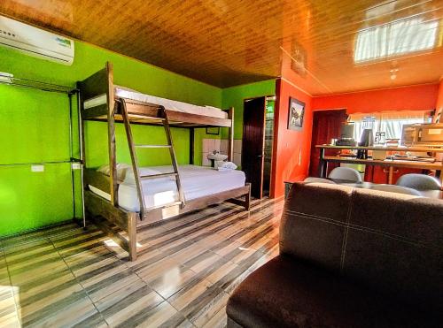 a room with a bunk bed and a couch at Cabinas Río Frío in San Rafael