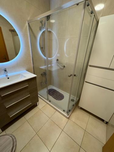 a bathroom with a shower and a sink at Sunflower Apartment in Armação de Pêra