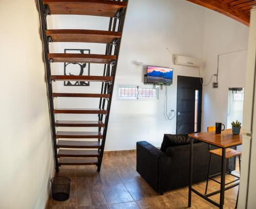 a spiral staircase in a living room with a table at Eleven in Posadas