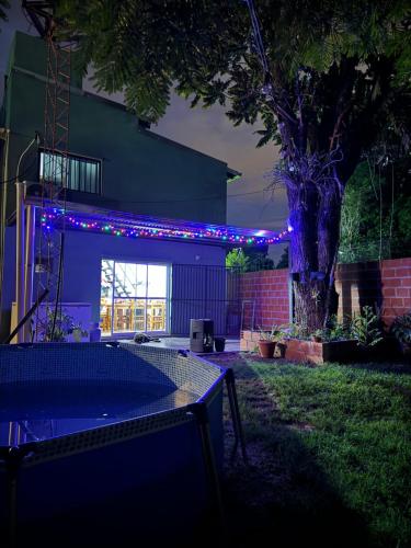 a ping pong table in a yard with blue lights at Eleven in Posadas