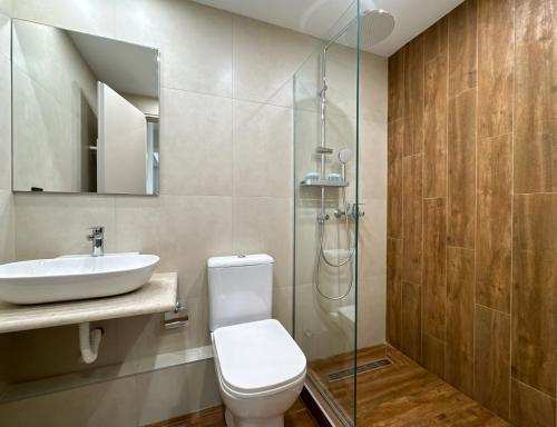 a bathroom with a toilet and a sink and a shower at GreenKaravan Suite in Thessaloniki