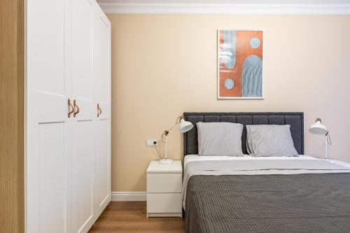 a bedroom with a bed and a painting on the wall at Kiztasi Apartments-Orange and Blue in Istanbul