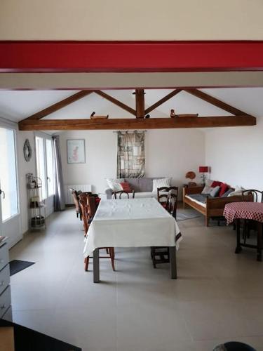 un salon avec une table et un canapé dans l'établissement Maison entière au cœur des vignes des Trois Bacchantes !, à Saint-Étienne-la-Varenne