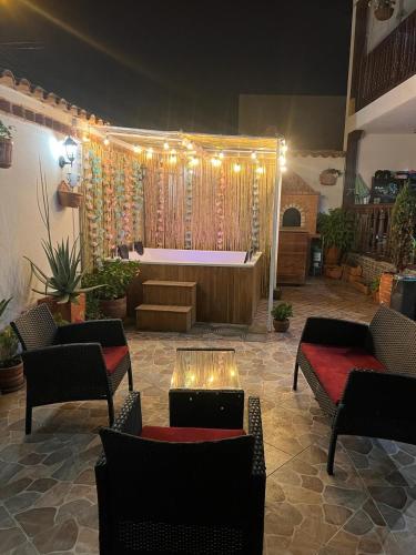a living room with a stage with a couch and chairs at Casa De Las Flores Hotel SPA in Villa de Leyva