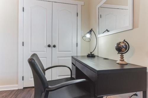 a black desk with a chair and a lamp at Valley Vista-Mins to SkylineDrive-Hot Tub-King, Queen Beds in Front Royal