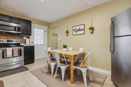 a kitchen with a table and chairs and a refrigerator at Valley Vista-Mins to SkylineDrive-Hot Tub-King, Queen Beds in Front Royal
