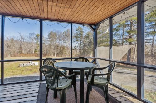 a screened in porch with a table and chairs at Valley Vista-Mins to SkylineDrive-Hot Tub-King, Queen Beds in Front Royal