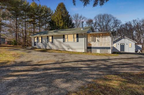 a white house with a garage on a driveway at Valley Vista-Mins to SkylineDrive-Hot Tub-King, Queen Beds in Front Royal