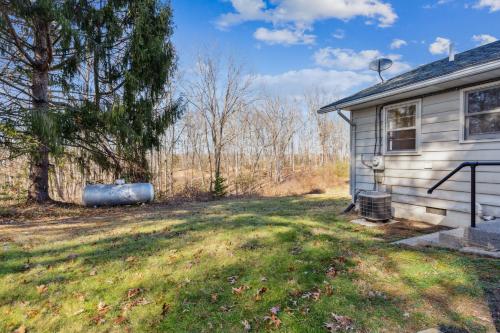 an empty yard next to a house with a tree at Valley Vista-Mins to SkylineDrive-Hot Tub-King, Queen Beds in Front Royal