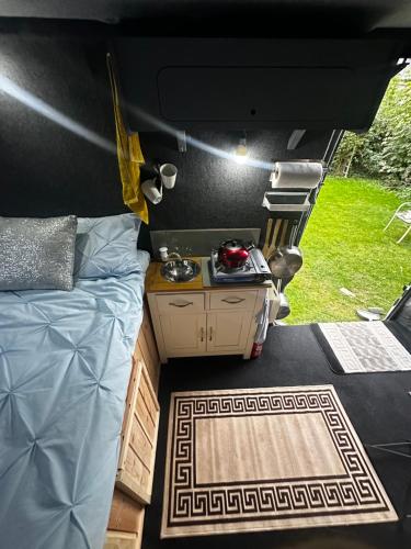a room with a bed and a table in a camper at VAN CONVERSION FOR ACCOMODATION in Waldingfield