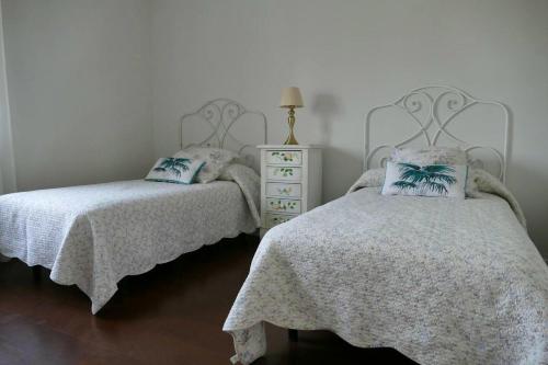 a bedroom with two beds and a night stand with a dresser at 2 bedrooms chalet with private pool terrace and wifi at Villamayor in Villamayor