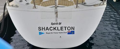 a boat sitting in the water with a sign on it at Spirit of Shackleton yacht in Puerto Calero