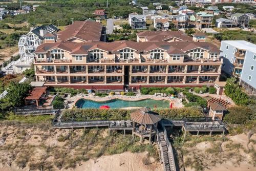 an aerial view of a resort with a swimming pool at Salty Shenanigans in Kill Devil Hills