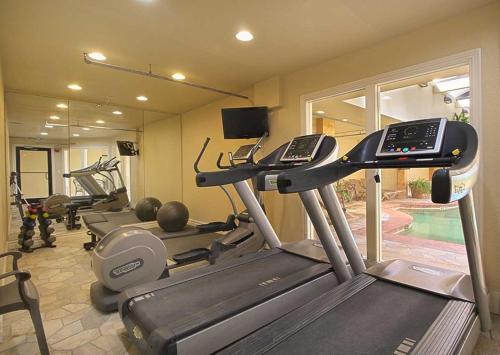a gym with several tread machines in a room at Salty Shenanigans in Kill Devil Hills
