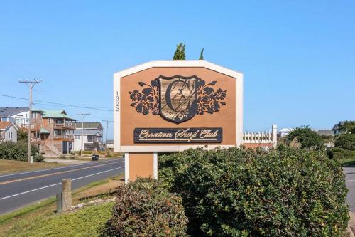 a sign for the beacon city inn on the side of the road at Salty Shenanigans in Kill Devil Hills