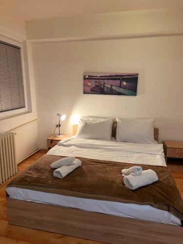 a bedroom with a bed with two towels on it at Aleks 4 in Skopje