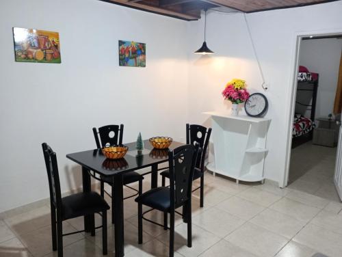 a dining room with a black table and chairs at Apartamento Centro histórico in Bogotá