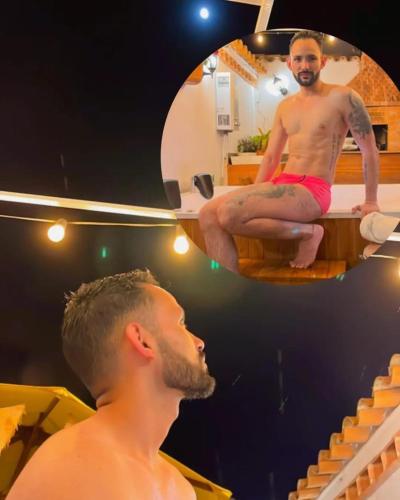 a man sitting on a bath tub in front of a mirror at Casa De Las Flores Hotel SPA in Villa de Leyva