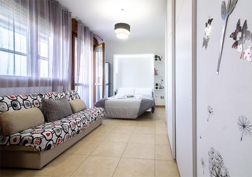 a living room with a couch and a bed at Bologna Fair Expo Apartment in Bologna