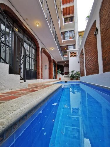 an empty swimming pool with blue water in a building at Casa Rey Sol Vallarta in Puerto Vallarta