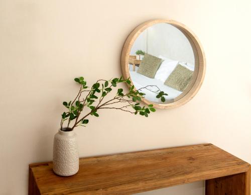 a vase sitting on a table with a mirror at Casa di Emmanuel in Kalymnos