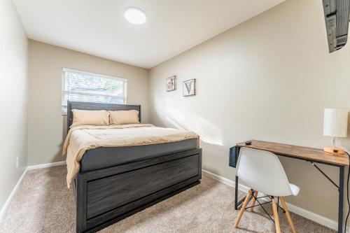 a bedroom with a bed and a desk at ZenHomes in Tampa near USF in Tampa