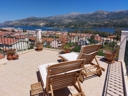 a balcony with two chairs and a view of a city at Nefeli seaview apartment in Argostoli