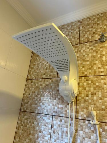 a shower head on the wall of a bathroom at BORA BORA RESIDENCE in Joinville