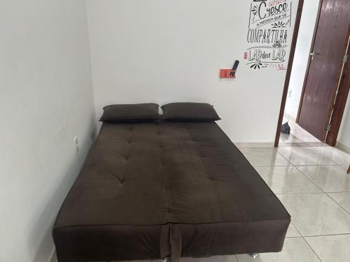 a large bed sitting in a corner of a room at BORA BORA RESIDENCE in Joinville