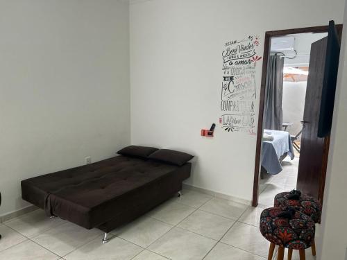 a bedroom with a bed in the corner of a room at BORA BORA RESIDENCE in Joinville
