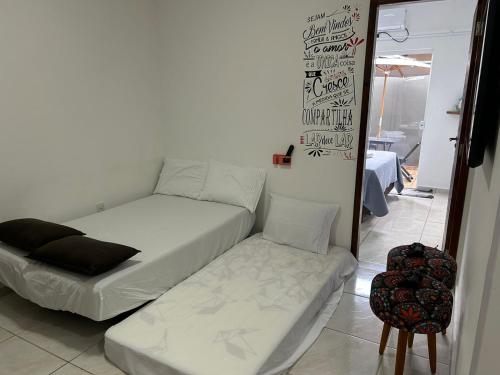 a bed and a couch in a room at BORA BORA RESIDENCE in Joinville