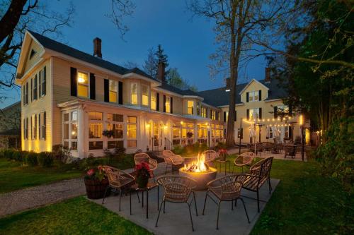 a house with a fire pit in the yard at The Lenox Collection in Lenox