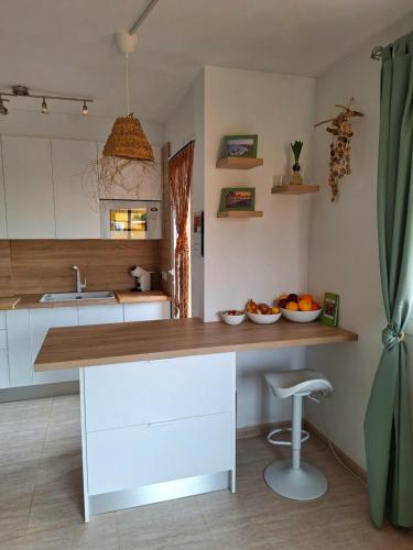 a kitchen with a counter with a bowl of fruit on it at Vera Sol y Mar - Naturist Zone in Playas de Vera