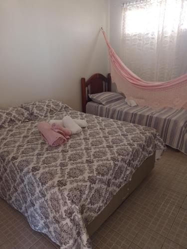 een slaapkamer met 2 bedden en roze handdoeken bij Pousada Rainha do Mar in Beberibe