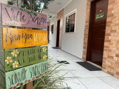 a sign in front of a house with writing on it at BORA BORA RESIDENCE in Joinville